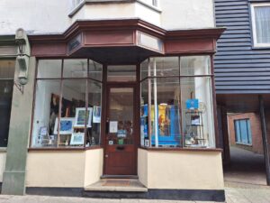 22 York Street, Ramsgate storefront  featuring large glass windows showcasing various pieces of art, and a central wooden door.