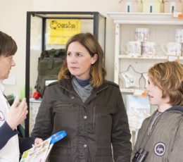 Two adults and a child discussing tourism