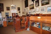 Museum exhibit with two models behind a counter