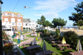 Overview of the grassed area with tables and benches