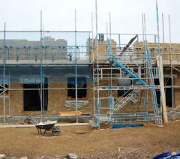 Scaffolding around the construction of the houses