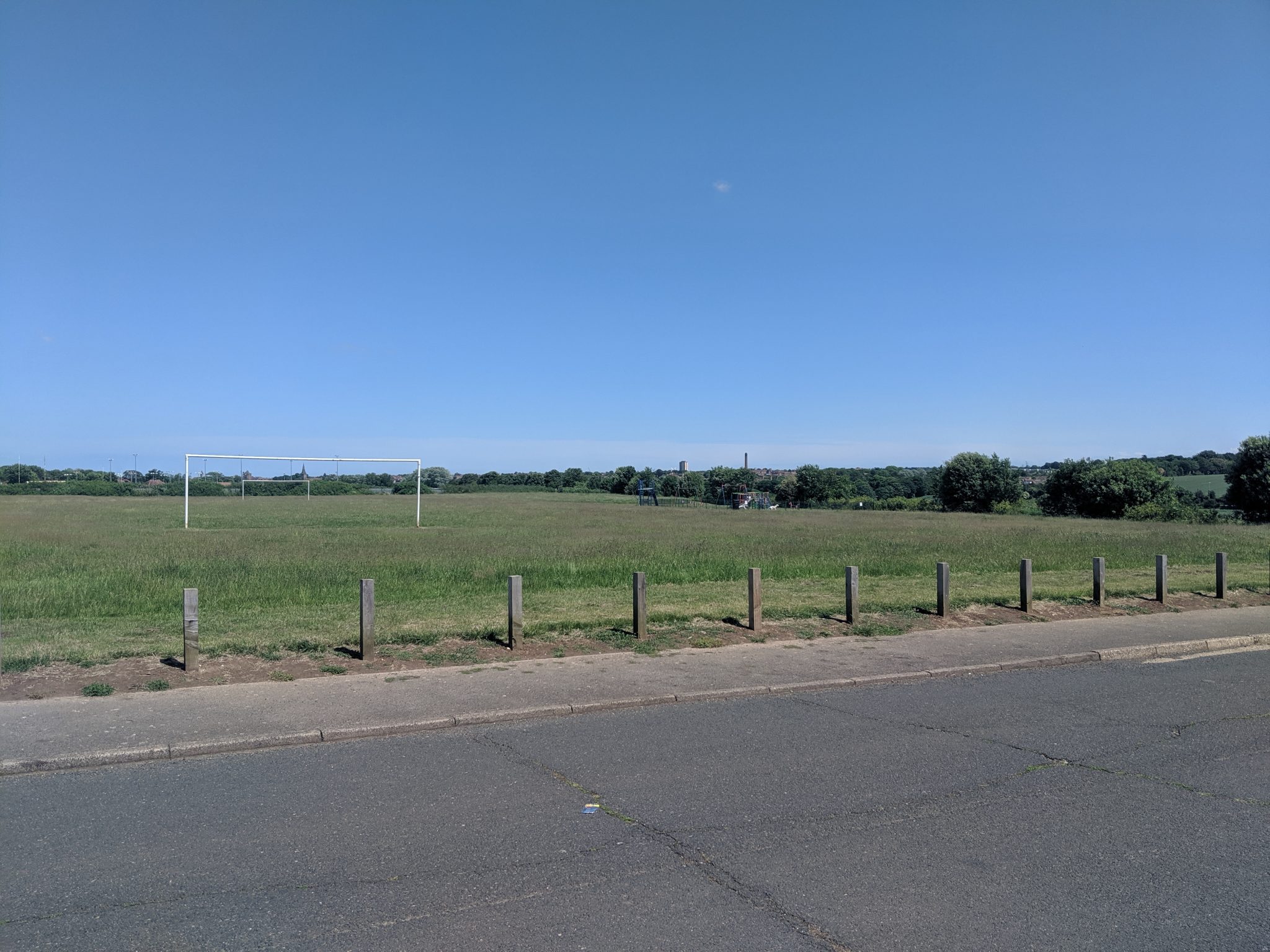 Large grassed area with football goals