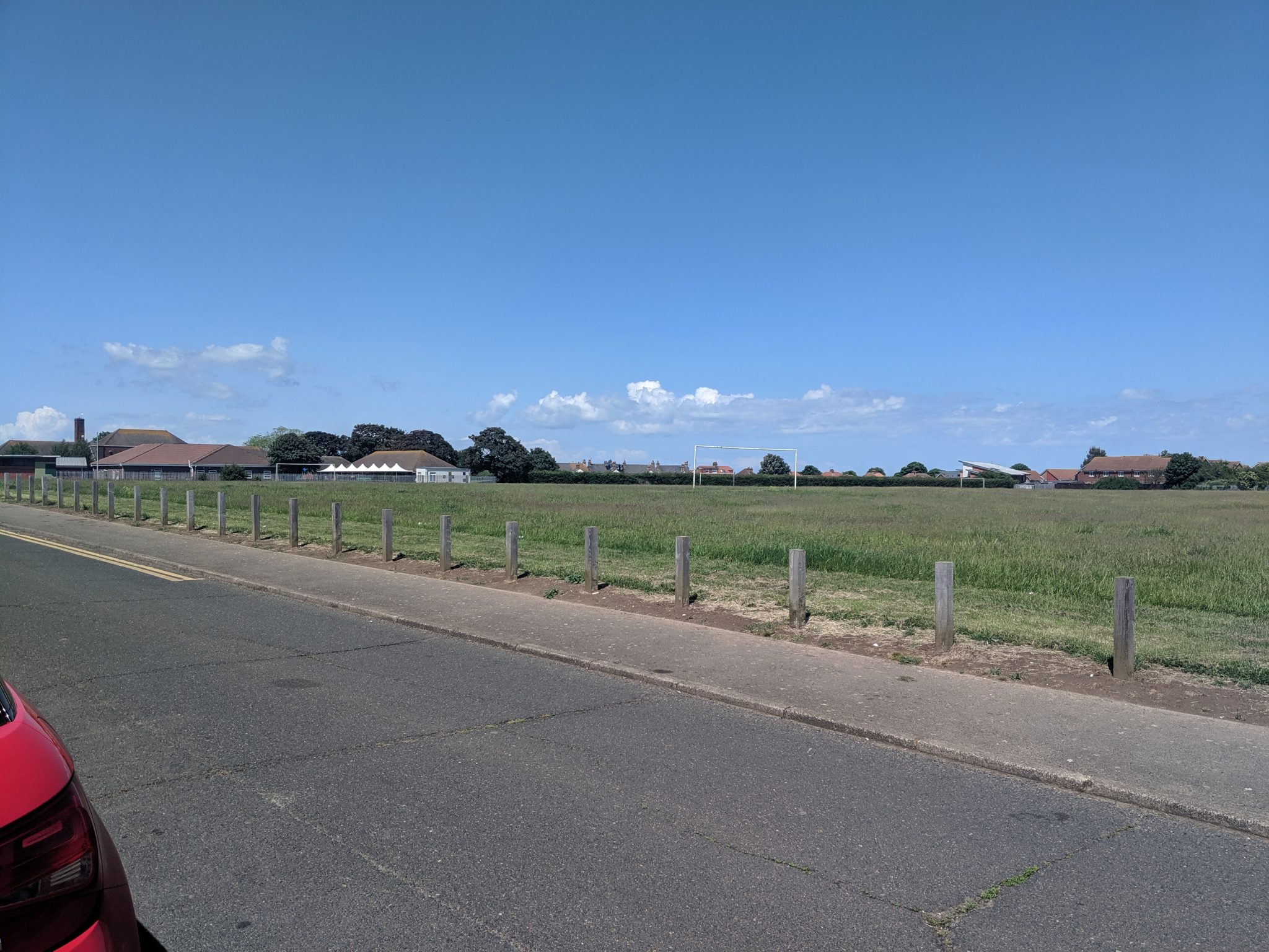 Large grassed area with football goals