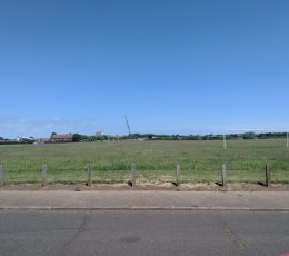 Large grassed area with football goals