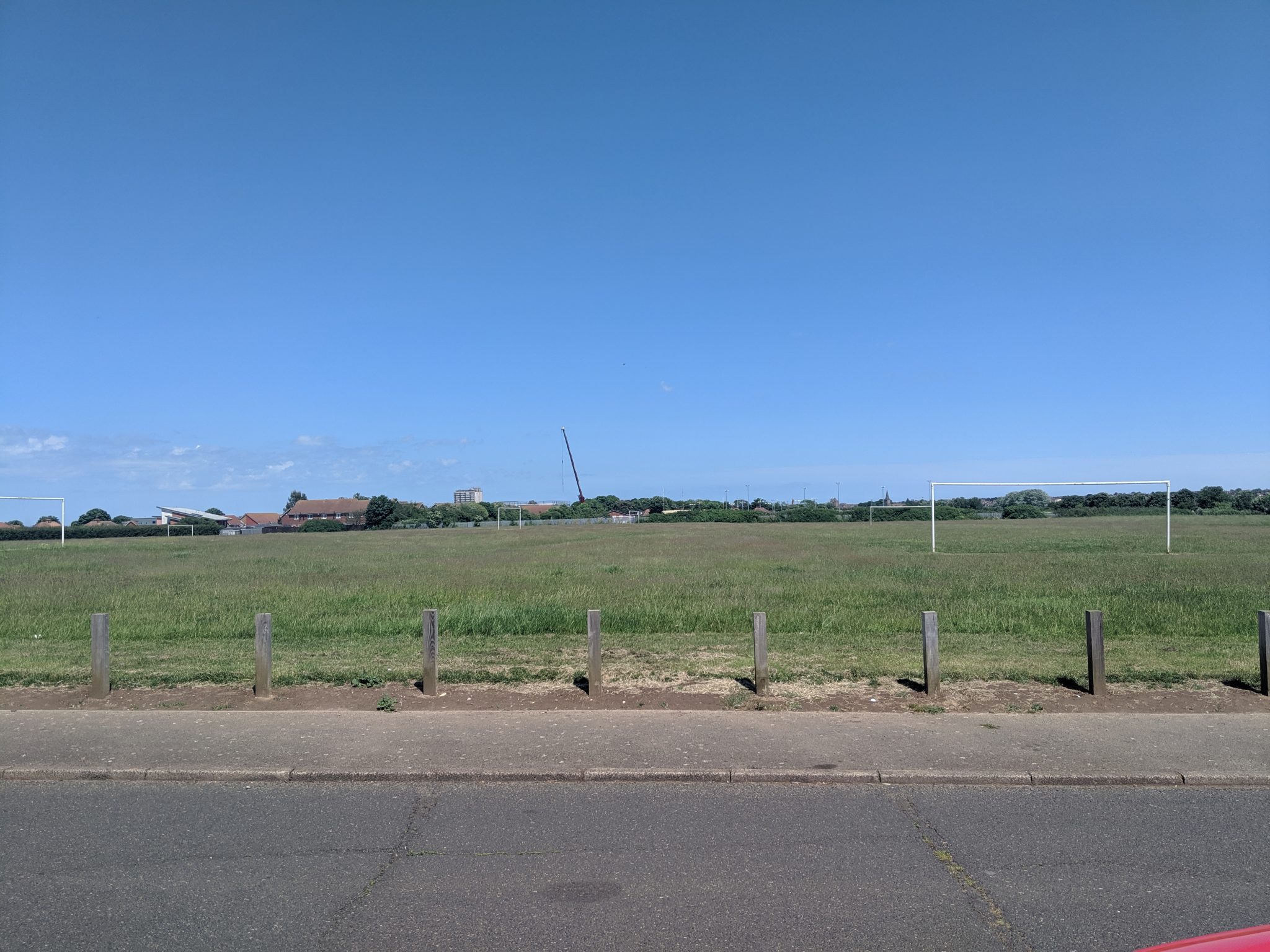 Large grassed area with football goals