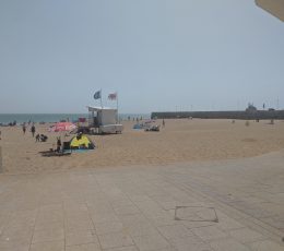 view of the beach and the harbour wall