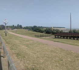 Pathway to a grassed area and small parking area with a view of the Viking Ship