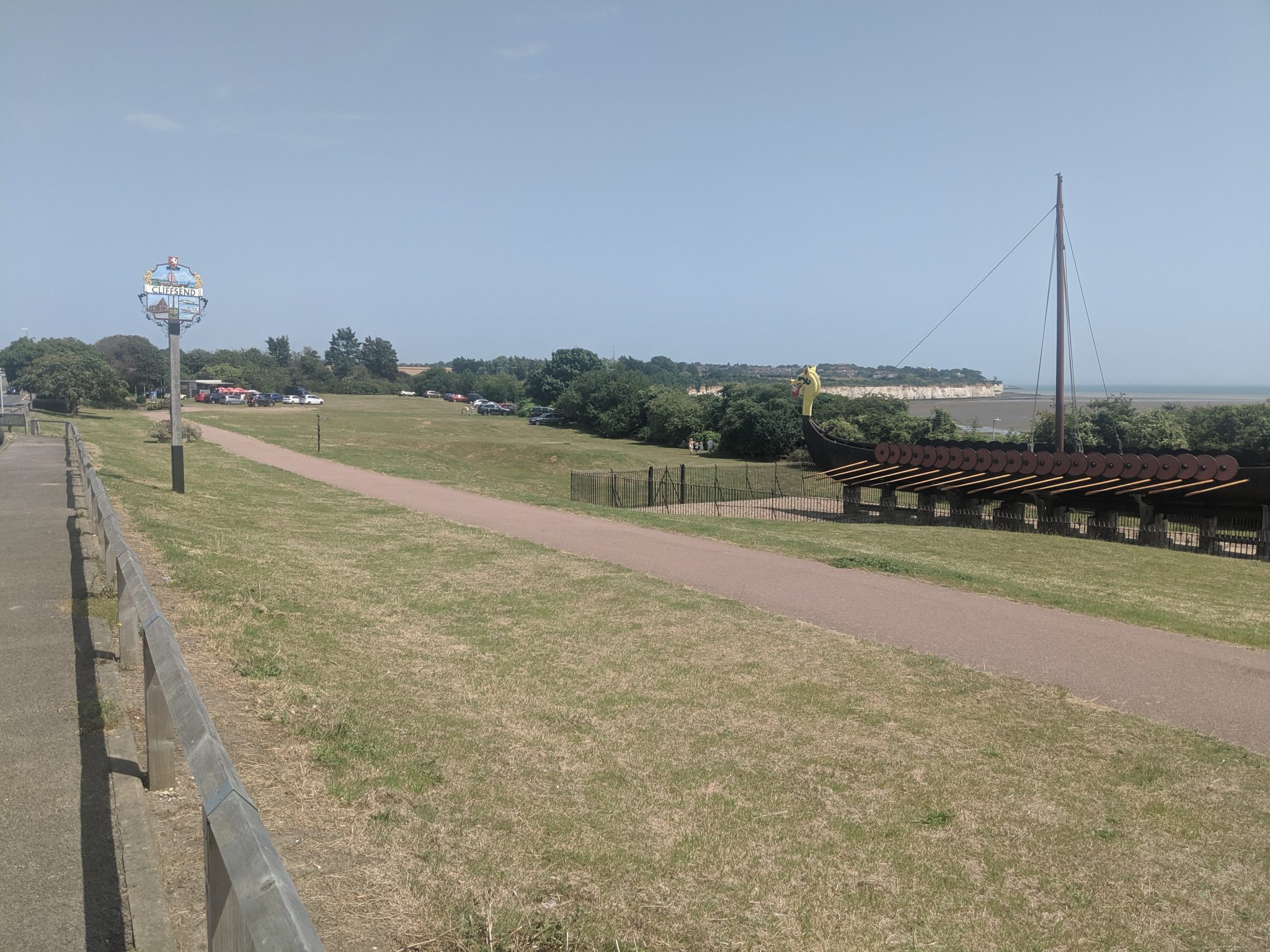 Pathway to a grassed area and small parking area with a view of the Viking Ship