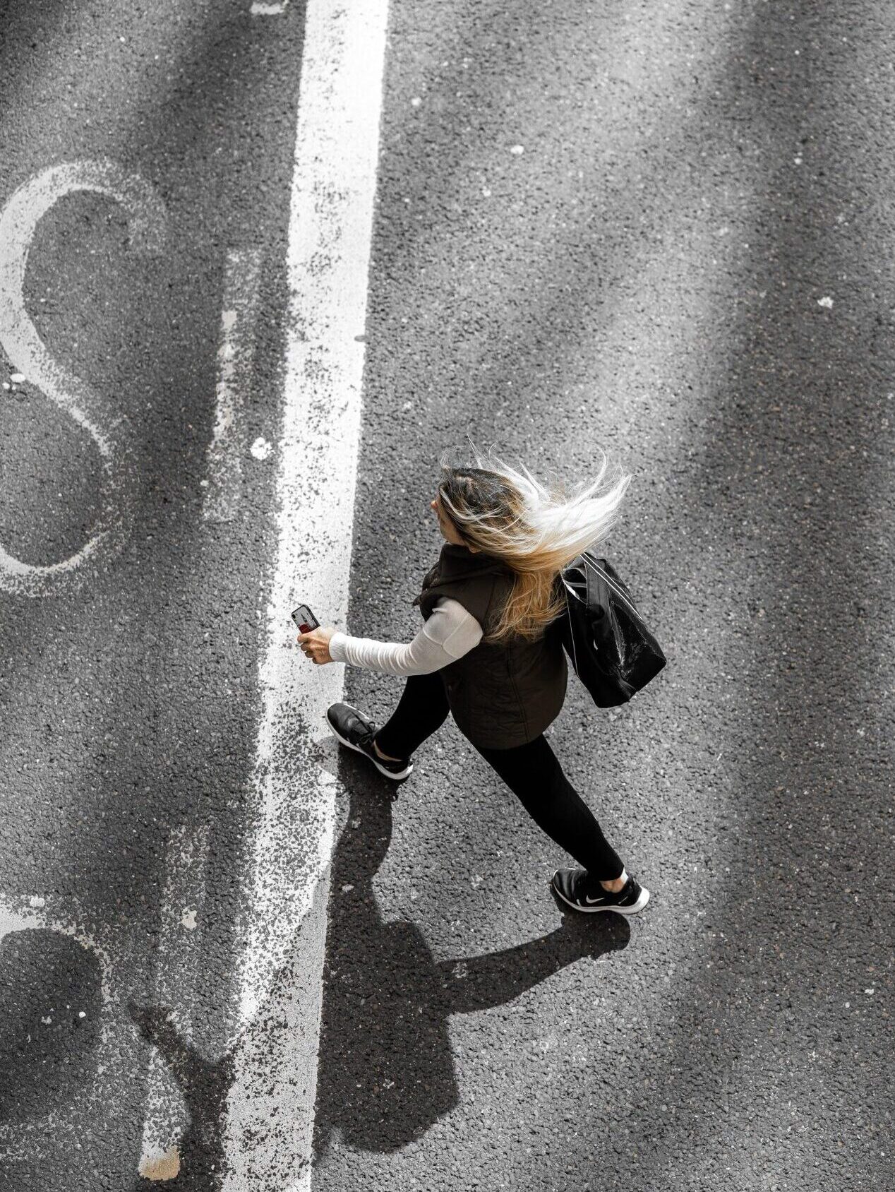 Above shot of woman crossing road
