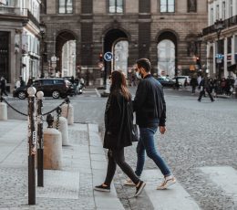 Couple walking across cobbled street