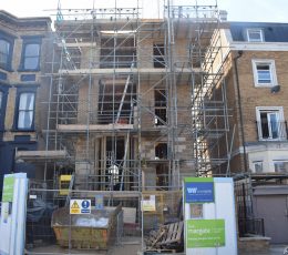House with scaffolding, construction nearly complete