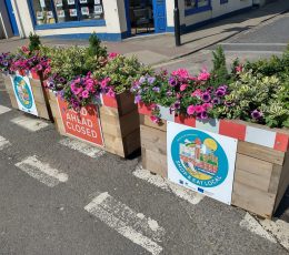 View of flower boxes showing temporary road closure