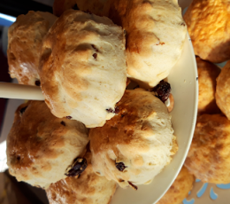 Close up image of a cake stand of fruit scones