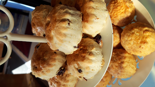 Close up image of a cake stand of fruit scones