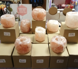 Cardboard boxes with pink crystal candles on top of them