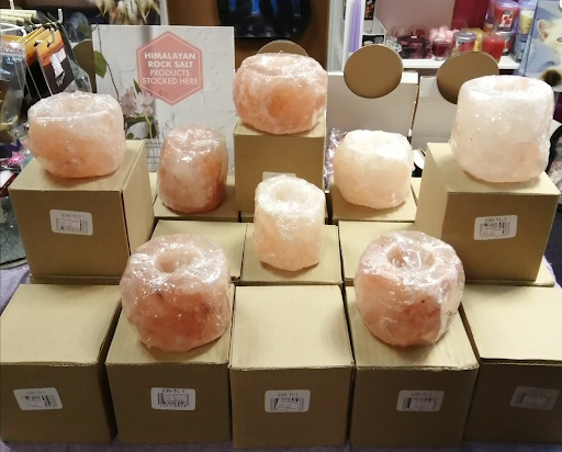 Cardboard boxes with pink crystal candles on top of them