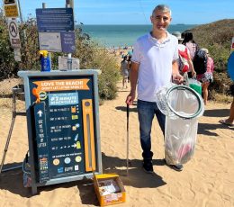 Volunteer with litter picker and collecting bag