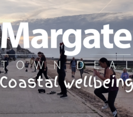 11 adults actively taking part in group outdoor keep fit activities on the lower promenade at Walpole Bay including steps and burpies.