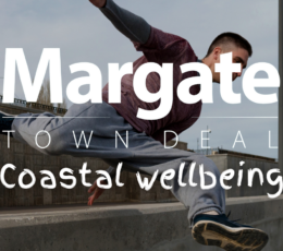 young male vaulting over a concrete wall doing urban parkour