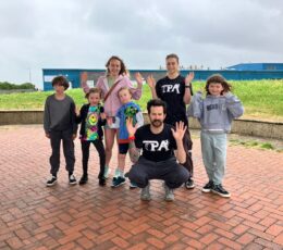 Thanet Parkour Academy coaches grouped with young people on upper promenade space at Walpole bay.