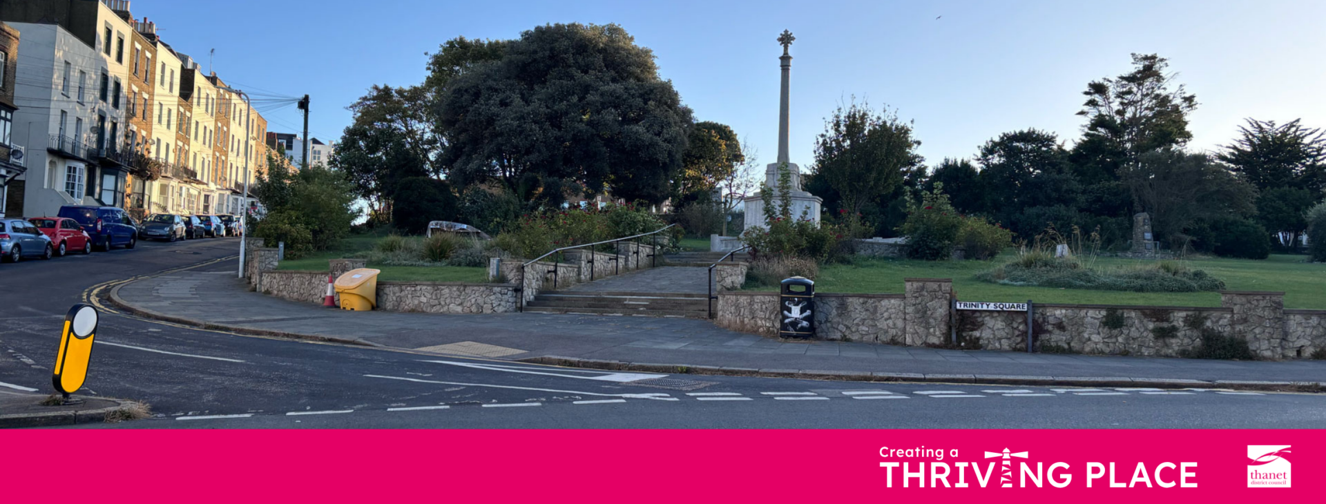 A photograph of Trinity Square in Margate. The image shows a public green space featuring a tall stone memorial monument, stone walls, and stairs leading up into the park. The foreground shows a paved pavement, a small yellow grit bin, and a street sign reading 'Trinity Square'. At the bottom, a pink branding banner features the text 'Creating a THRIVING PLACE' and the Thanet District Council logo.