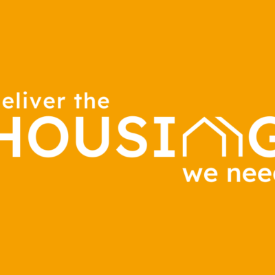 Text reads Deliver the Housing we need. On an orange background
