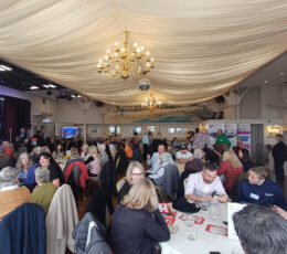 People sitting at tables inside the Pavilion in Broadstairs. The room is decorated for an awards ceremony.
