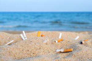 Cigarette butts discarded on a beach.