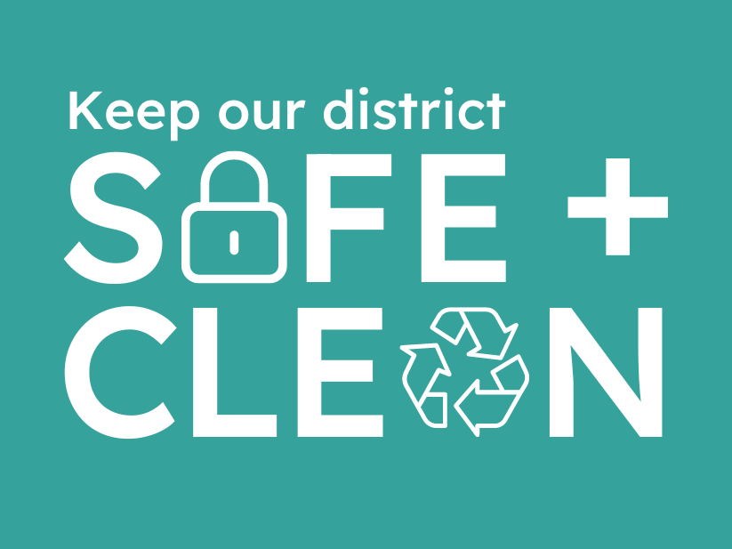 Keep our district safe and clean in white text on teal background the A in safe is the line drawing of a padlock and the A in clean is the line drawing of a recycling symbol