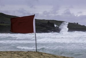 Red flag in front of stormy ocean