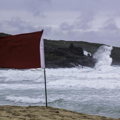 Red flag in front of stormy ocean