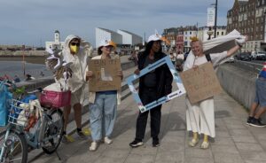 A group of people dressed as seagulls standing on the Margate promenade, as part of ‘Protect Our Waterways’ - Seagull litter pick and parade (CleanupUK, RUCU and Plastic Free Thanet)