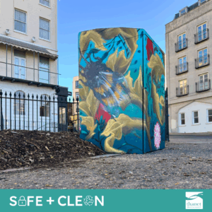 A large bin which has been spray painted with a bee design