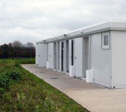 white building on hard standing surrounded by grass