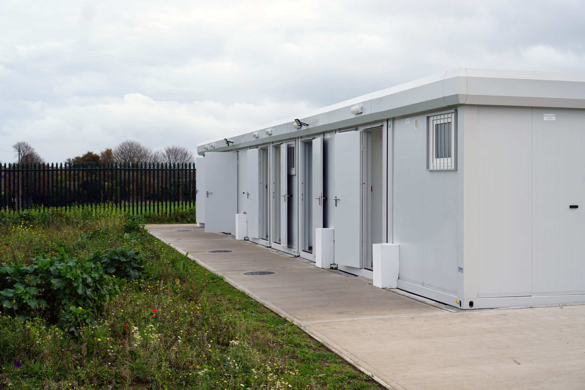 white building on hard standing surrounded by grass